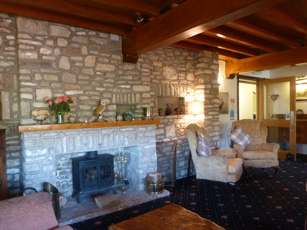 The lounge has a wood burner and cosy furniture